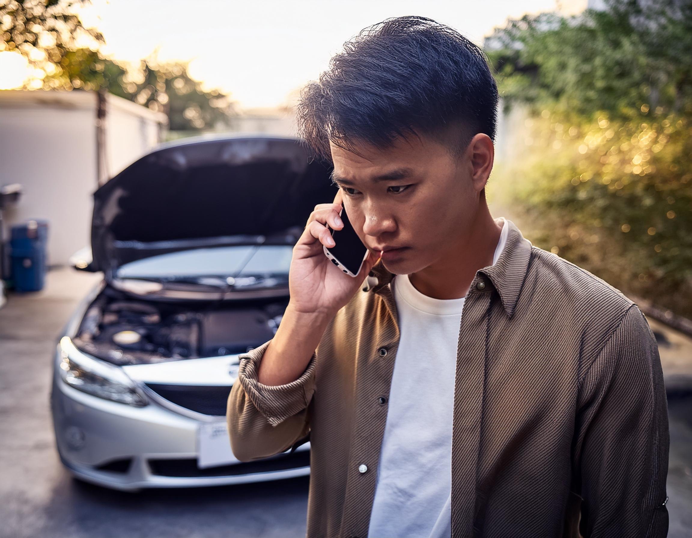 unhappy-customer-cellphone-driveway-car-broken.jpg